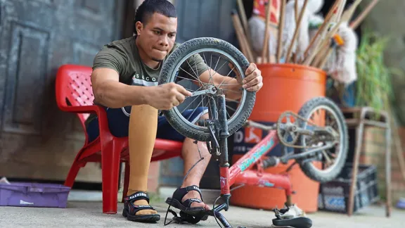 Ramón ersetzt einen kaputten Fahrradreifen.  Foto: LWB Kolumbien