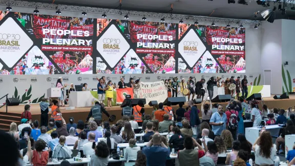 21. November 2025, Belém, Brasilien: Angehörige indigener Bevölkerungsgruppen stimmen am eigentlich geplant letzten Tag der COP30 auf der Bühne „Widerstandslieder“ an. Foto: LWB/A. Hillert 