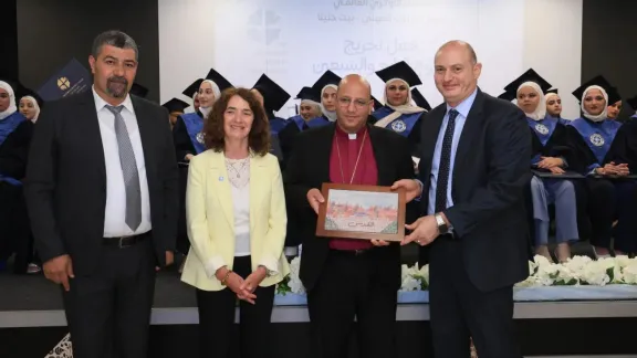 The VTP Director presents a gift to Bishop Imad Haddad, featuring a portrait created by the Vocational Training Program trainees, during the graduation ceremony. Photo: LWF Jerusalem